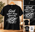 God Don't Play About Me shirt with detailed fist gripping lightning, studio product photography